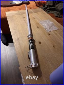Disney Parks legacy-style lightsaber looks like a green blade, metal hilt
